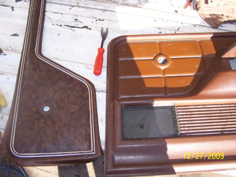 1978 Ford Bronco - Two interior door panels, possibly from a truck, are laid out on a surface with a trim removal tool nearby.