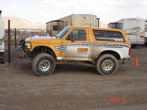2006 Dodge 2500 - This modified SUV features off-road tires, a custom bumper, and racing decals, suggesting it's prepared for desert racing events.