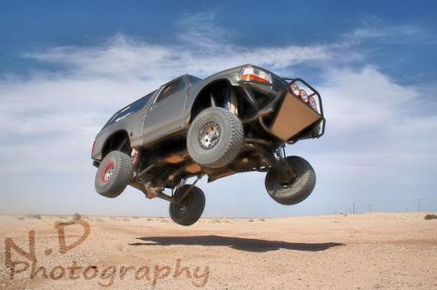 2006 Dodge 2500 - Custom off-road truck airborne during a desert jump.