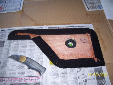 1978 Ford Bronco - Car door panel being worked on, placed on newspapers with a utility knife nearby. Text indicates 'Drive Inside'.