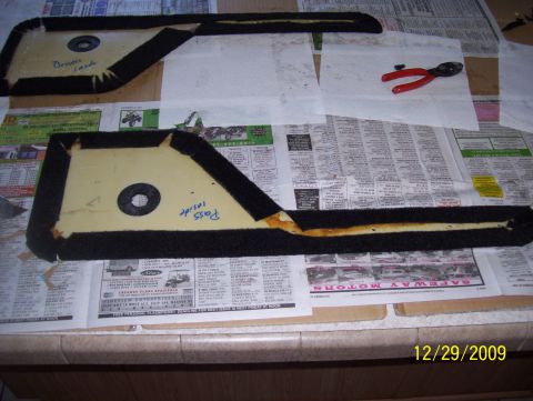 1978 Ford Bronco - Two car door panels are laid out on newspapers, with a pair of wire cutters nearby.