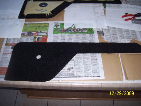 1978 Ford Bronco - Carpet trim pieces are laid out on newspapers, ready for installation or modification.