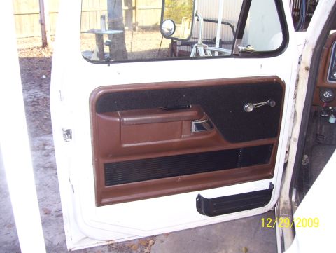 1978 Ford Bronco - Interior view of a vehicle door panel with brown and black trim, showing a date stamp in the corner.