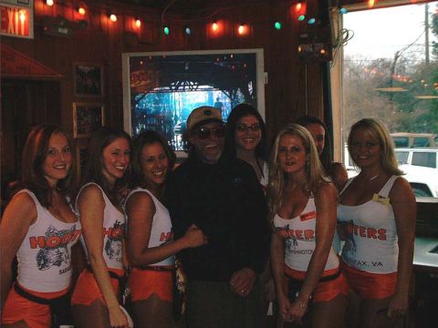 2000 Ford Crown Victoria - People pose for a photo inside a Hooters restaurant.