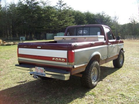 1990 Ford F-150 - This 1990 Ford F-150 pickup truck is shown from a rear three-quarter angle, with a toolbox mounted in the bed.