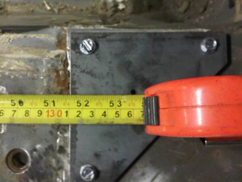 1996 Ford Bronco - A measuring tape is used to measure a metal plate, likely for a custom build or repair.