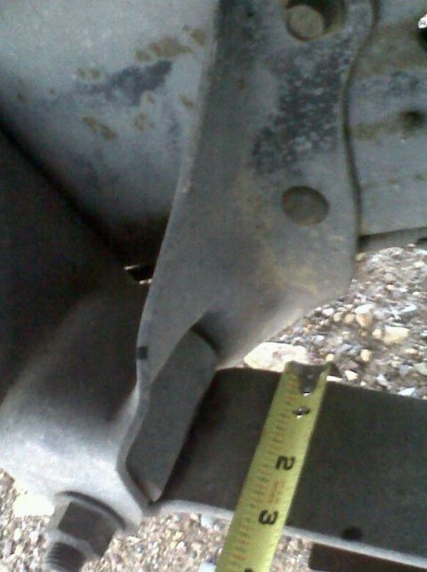 1989 Ford Bronco - Measuring a bracket on a vehicle frame. The tape measure shows 2 inches.