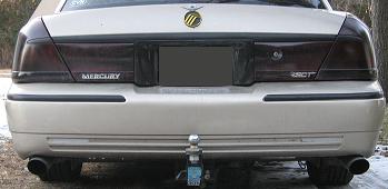 2000 Mercury Grand Marquis - The rear of a 2000 Mercury Grand Marquis sedan, tinted taillights and a trailer hitch assembly.