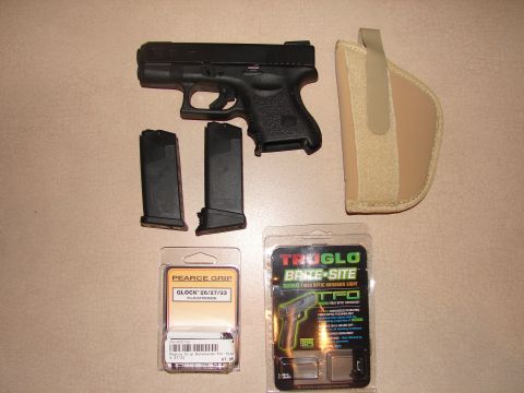 1996 Ford Bronco - A Glock pistol is displayed with two magazines, a holster, and packaging for a Pearce Grip extension and a Truglo sight.