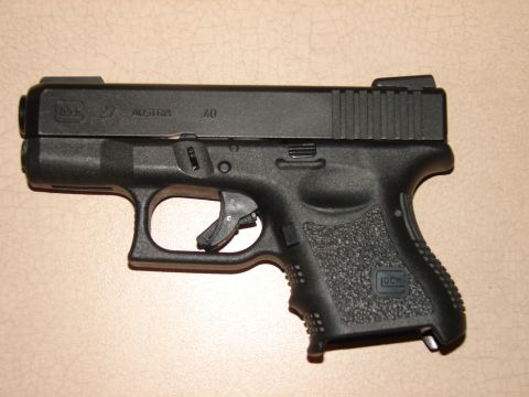 1996 Ford Bronco - A black Glock 27 pistol, chambered in .40 S&W, is shown with Austrian manufacturing marks visible on the slide.