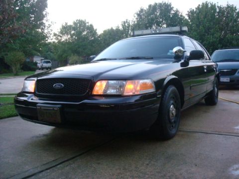 2003 Ford Crown Victoria - This black 2003 Ford Crown Victoria police car is shown from a 3q-front angle.