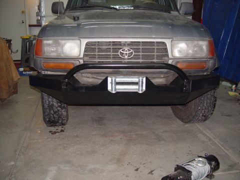 1993 Ford Bronco - This Toyota Land Cruiser features a heavy-duty aftermarket bumper with a winch, suggesting off-road modifications. The vehicle's body style…