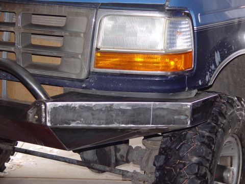 1993 Ford Bronco - Custom steel bumper installed on a blue 1992 Ford F-Series truck, showing the front-end modifications.