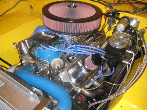 1970 Ford Bronco - Close-up view of a modified engine bay, polished components and aftermarket parts.