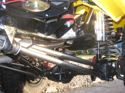 1970 Ford Bronco - Close-up view of the undercarriage and suspension system of a modified off-road vehicle.