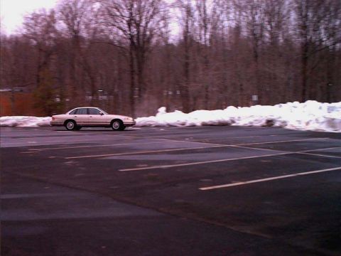 2000 Ford Crown Victoria - Side view of a 2000 Ford Crown Victoria in a parking lot during winter.