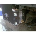 1989 Ford Bronco - Close-up of a heavily rusted vehicle frame section, showing damage and mounting points.