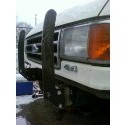 1989 Ford Bronco - Close-up of the front grille and headlight assembly of a 1989 Ford Bronco, a prominent 4x4 badge and a heavy-duty brush guard.