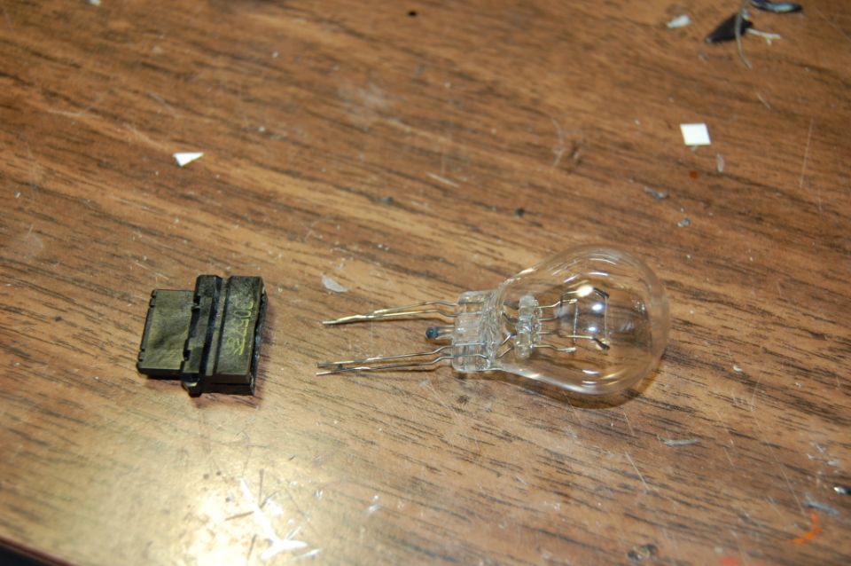 Light bulb and socket on wooden surface