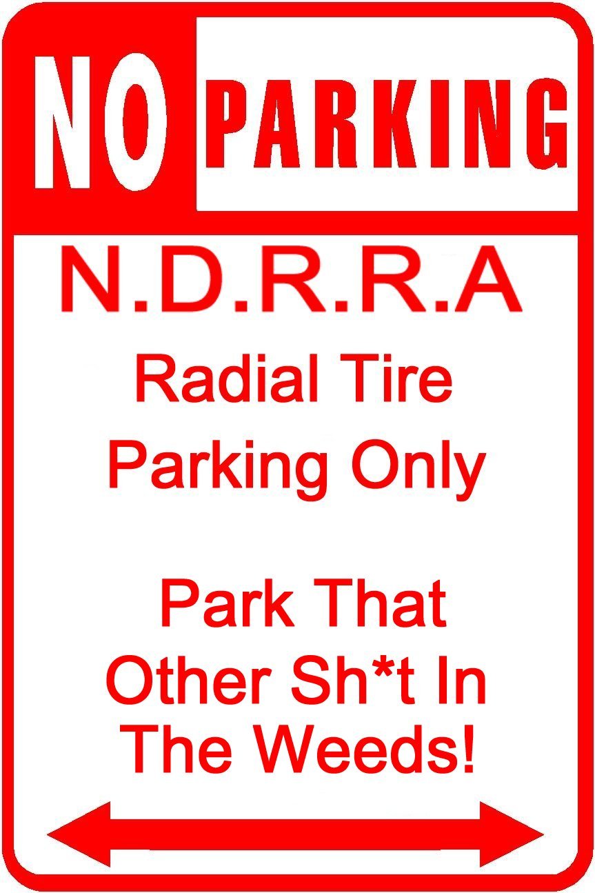 Red and white sign with 'NO PARKING' at the top, followed by 'N.D.R.R.A Radial Tire Parking Only' and 'Park That Other Sh*t In The Weeds!' with arrows pointing left and right