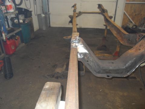 1997 Ford Ranger - A vehicle frame is shown on jack stands in a garage, undergoing some work.