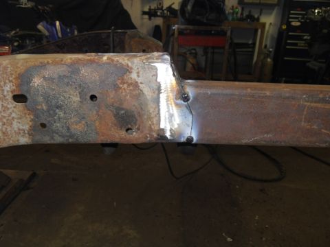 1997 Ford Ranger - Close-up of a heavily rusted vehicle frame section showing recent welding repairs.