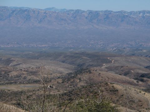 1996 Ford C-350 (Centurion Conversions) - A vast, arid landscape unfolds under a clear blue sky, with mountains forming a distant backdrop.
