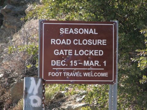 1996 Ford C-350 (Centurion Conversions) - A sign informs visitors that the road is seasonally closed and the gate is locked from December 15th to March 1st, but foot travel is welco…