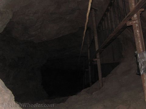 1996 Ford C-350 (Centurion Conversions) - Interior of a dark cave with metal bars and supports on the right side.