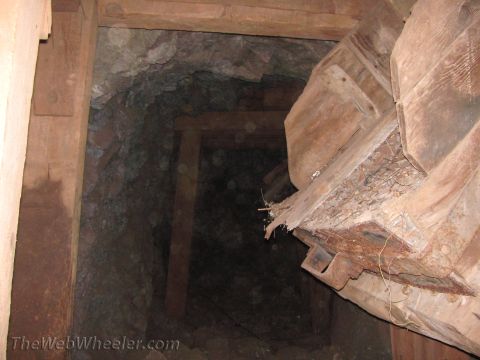 1996 Ford C-350 (Centurion Conversions) - Interior of a mine shaft showing wooden supports and rocky walls.