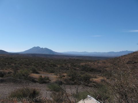 1996 Ford C-350 (Centurion Conversions) - Expansive desert scenery with distant mountains under a bright blue sky.