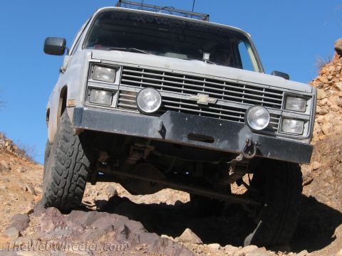 1996 Ford C-350 (Centurion Conversions) - This lifted K5 Blazer is navigating a rocky trail under a clear blue sky.