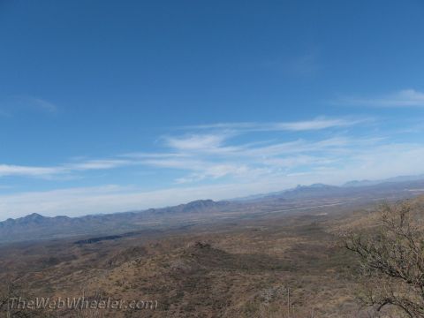 1996 Ford C-350 (Centurion Conversions) - A wide view of a desert landscape with distant mountains under a bright blue sky.