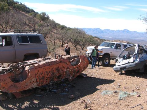 1996 Ford C-350 (Centurion Conversions) - Debris from vehicles in a desert landscape with mountains in the distance.