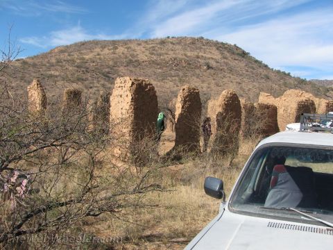 1996 Ford C-350 (Centurion Conversions) - The photo shows a white vehicle in the foreground with ancient adobe structures in the background under a blue sky.