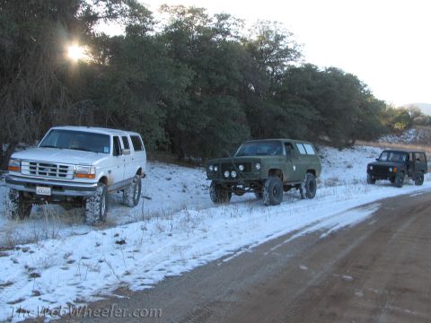 1996 Ford C-350 (Centurion Conversions) - A white 1996 Ford C-350 Centurion Conversions SUV is seen with other off-road vehicles in a snowy landscape.