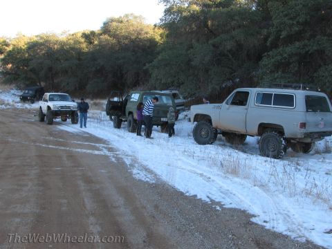 1996 Ford C-350 (Centurion Conversions) - Off-road vehicles are parked on a snowy dirt road during a trip.