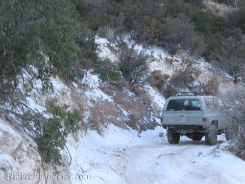 1996 Ford C-350 (Centurion Conversions) - A K5 Blazer navigates a snowy, mountainous dirt road.