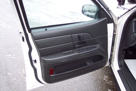 2001 Ford Crown Victoria - Interior view of the driver's side door panel on a 2001 Ford Crown Victoria.