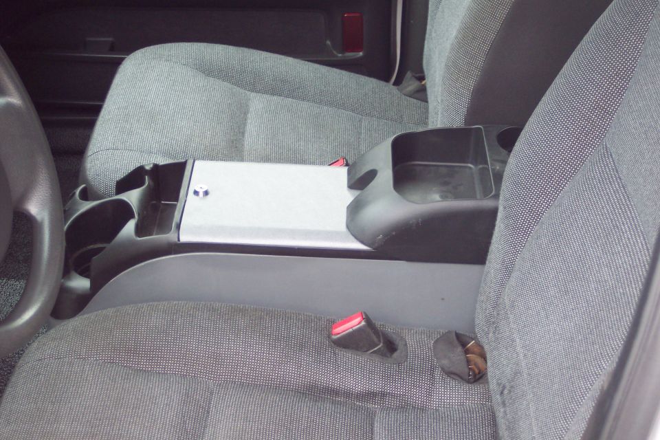 Interior view of gray cloth seats and center console with cup holders