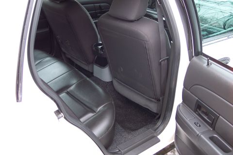 2001 Ford Crown Victoria - Interior view of a 2001 Ford Crown Victoria, highlighting the rear seating area and door trim.