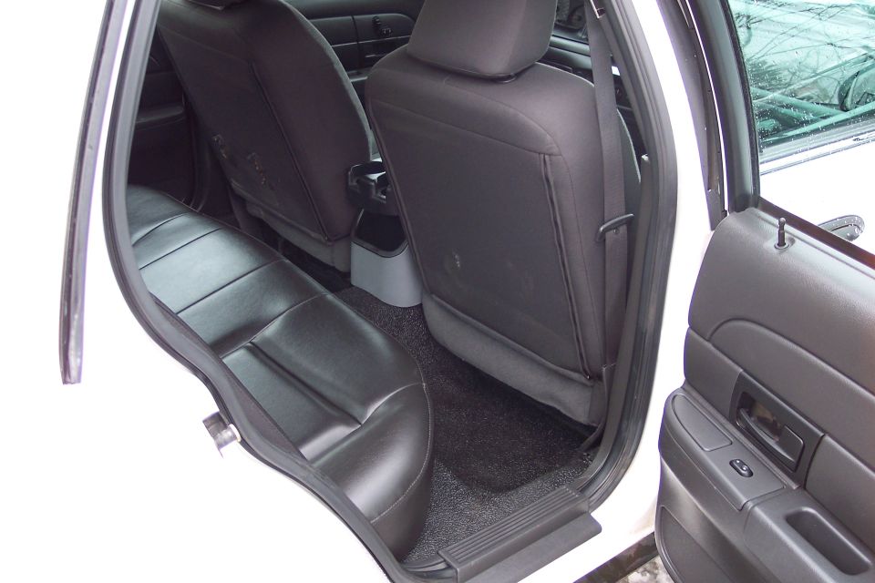 2001 Ford Crown Victoria interior showing black vinyl rear seats and door panel