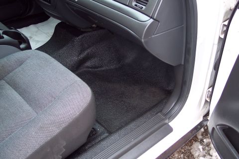 2001 Ford Crown Victoria - The interior of a 2001 Ford Crown Victoria features a driver's seat and a durable black floor.