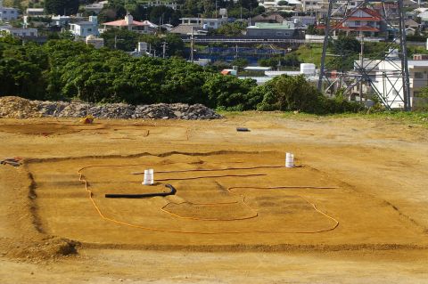 1986 Ford Bronco - An archaeological dig site is prepared with trenches and piping, with a town visible on the hill behind it.