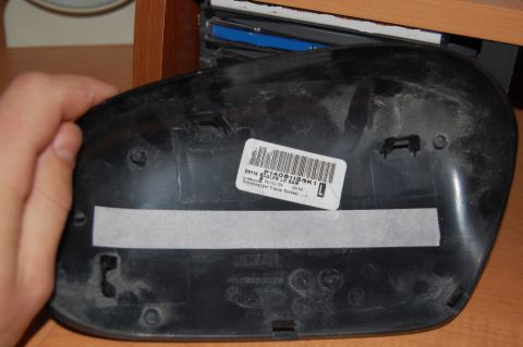 1985 Mercury Grand Marquis - The back of a black car mirror housing is shown, with a label indicating part number P1409119AK1.