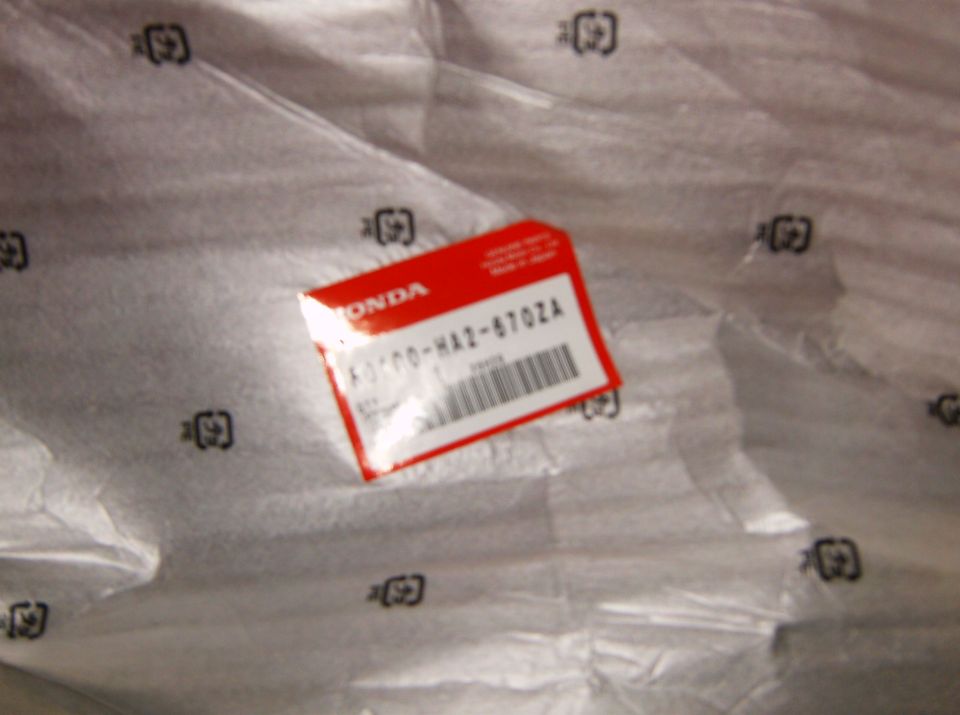 Honda part in red packaging with part number K0100-HA2-6702A