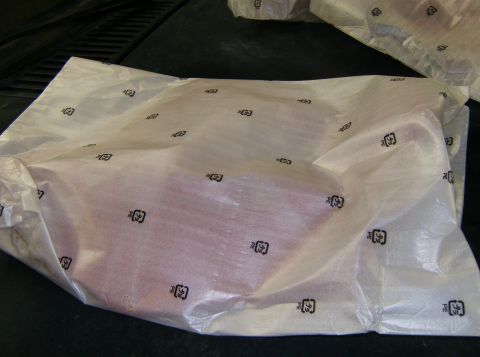 2000 Ford E350 - A part is covered in protective plastic wrap, which is marked with recycling symbols.