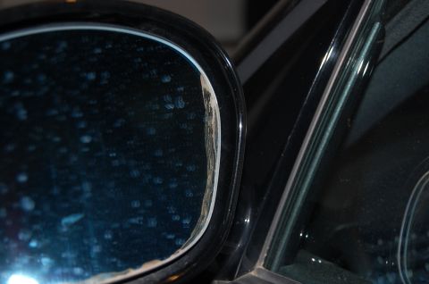 2002 BMW M3 - The side mirror housing on this vehicle shows signs of wear and damage.