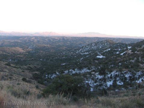 1996 Ford C-350 (Centurion Conversions) - A wide view of a desert landscape with snow dusting the hills and sparse vegetation.