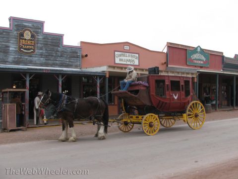 1996 Ford C-350 (Centurion Conversions) - A horse-drawn stagecoach is parked on a street in front of buildings labeled 'Bronco Trading', 'Campbell & Hatch Billiards', and 'Tombstone…